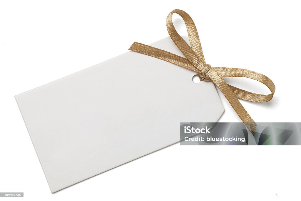 Gift Tag with Bow Blank gift tag and gold ribbon bow isolated on white with clipping path. Gift Tag - Note Stock Photo