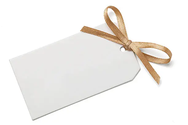 Blank gift tag and gold ribbon bow isolated on white with clipping path.