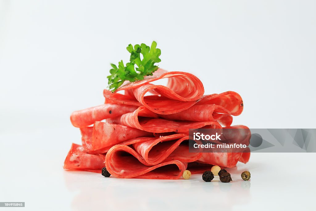 Heap of sliced salami isolated on white Antipasto Stock Photo