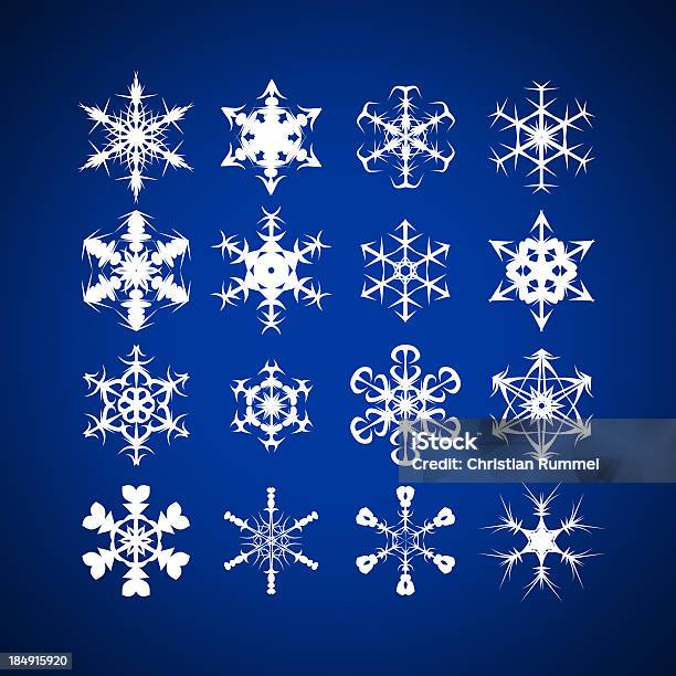 Snowflakes With Different Shapes Against Blue Background Stock Photo - Download Image Now