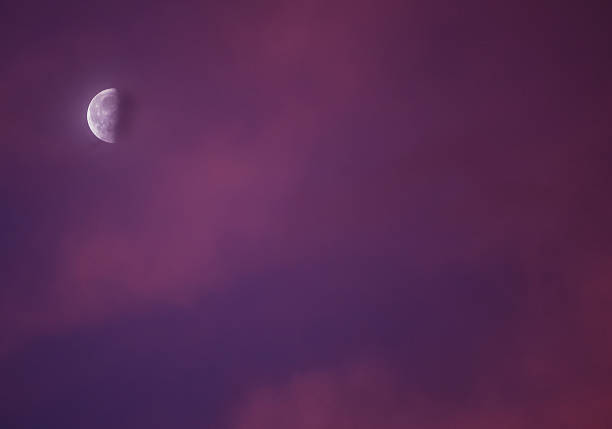 istock Moon behind the colorful sunrise clouds 184916138