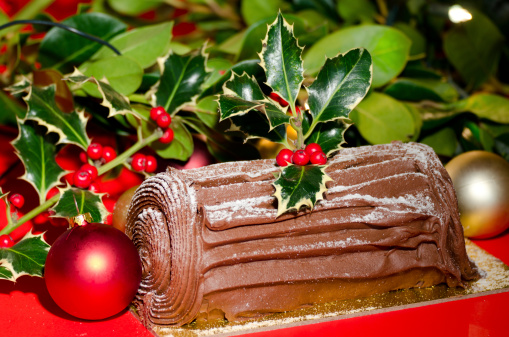 Chocolate Yule log with a seasonal Christmas background - studio shot with a shallow depth of field