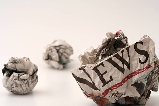 Bad news #2 ball of generic newspapers with the word NEWS visibleView other variations of the concept: evil corporation stock pictures, royalty-free photos & images