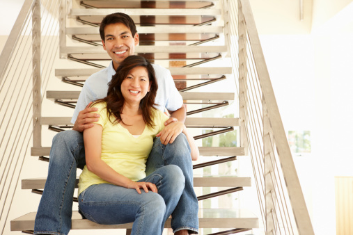 Asian couple portrait sat on the stairs