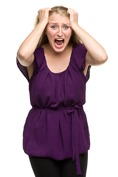 Frantic Young Woman Screaming Portrait of a young woman on a white background. http://s3.amazonaws.com/drbimages/m/hb.jpg hysteria stock pictures, royalty-free photos & images