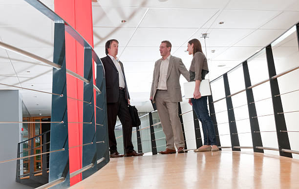 istock business people talking in hallway 184917281