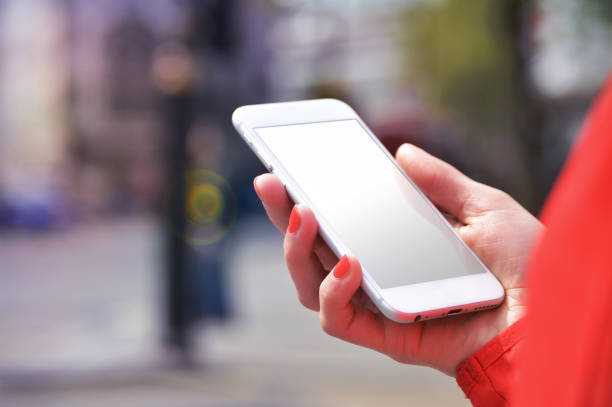 istock Mobile phone mockup with blank screen on white background for advertising, featuring a hand 1849174579