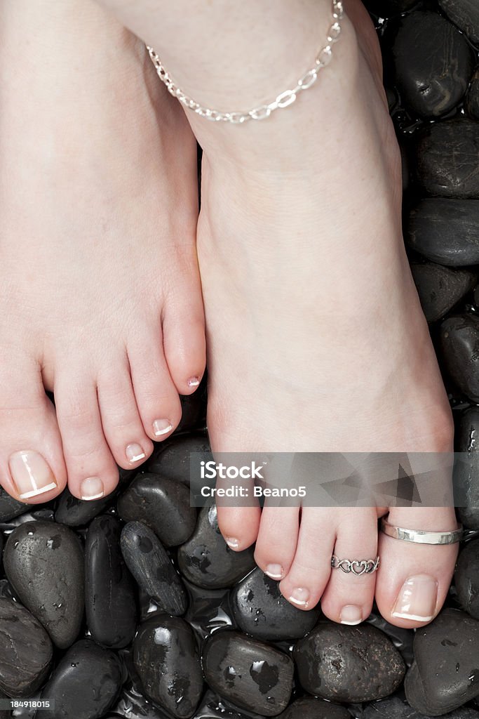 Toe Rings Lady modelling two toe rings and an anklet on wet pebbles. Anklet Stock Photo