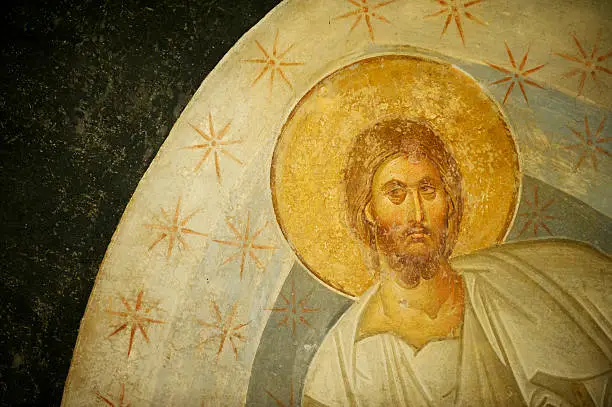 Byzantine fresco painting of Jesus Christ with gold leaf halo and shining stars