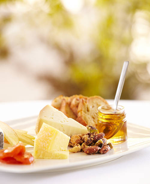 istock Fancy cheese plate with bread and honey outdoors 184918134