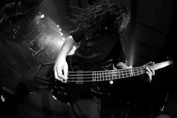 Bassist on stage in black &