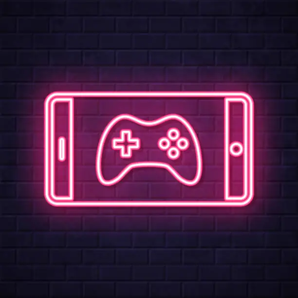Vector illustration of Video game on smartphone. Glowing neon icon on brick wall background