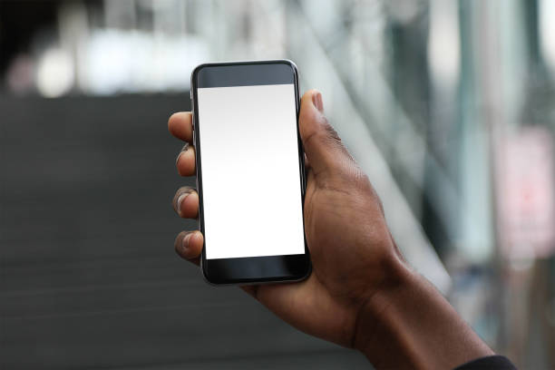 istock Mobile phone mockup with blank screen on white background for advertising, featuring a hand 1849186044