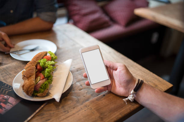 istock Mobile phone mockup with blank screen on white background for advertising, featuring a hand 1849188222