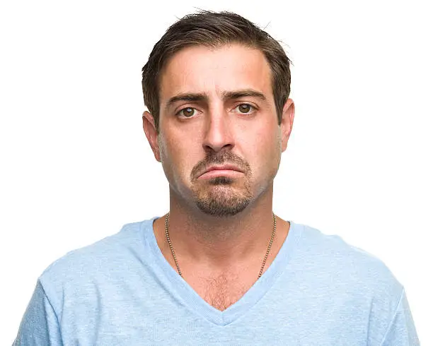 Photo of Sad man in a light blue T-shirt on a white background