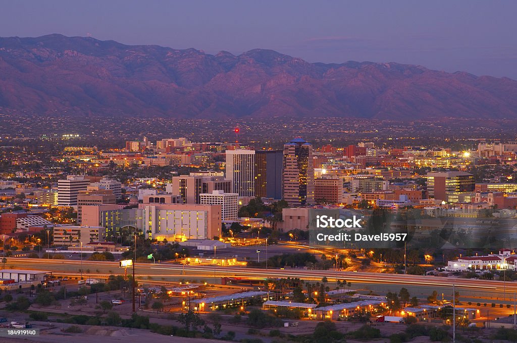 Tucson skyline and Catalina Mountains at dusk Tucson downtown skyline and aerial overview (including the University of Arizona) w/ Catalina Mountains at dusk. Tucson Stock Photo