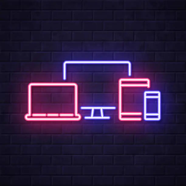 Vector illustration of Desktop computer, laptop, tablet PC and smartphone. Glowing neon icon on brick wall background