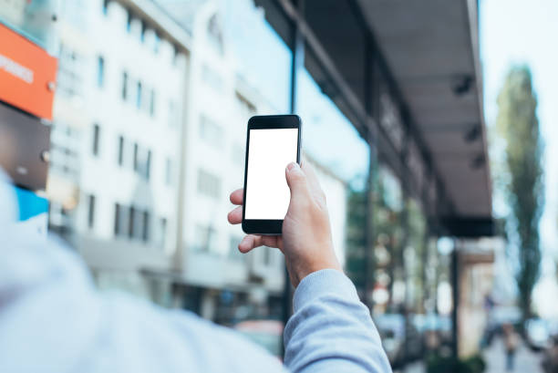 istock Mobile phone mockup with blank screen on white background for advertising, featuring a hand 1849198489