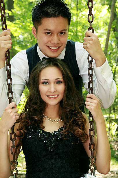 Formal Couple on Swing happy couple in their twenties in formal wear on swing outside modelkt stock pictures, royalty-free photos & images