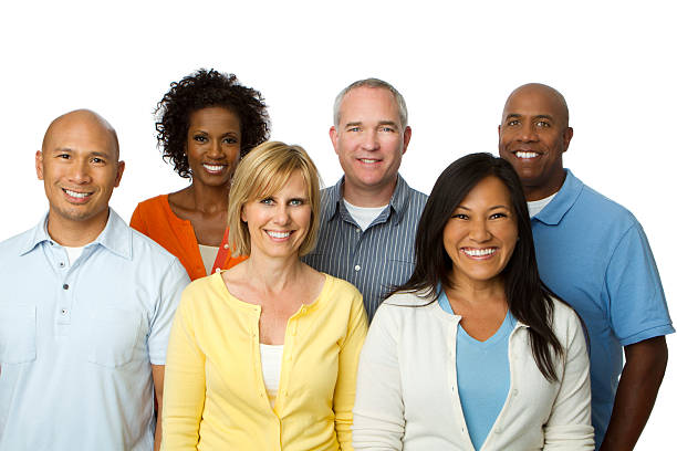 A group of people dressed in casual clothing.  Several have on jeans and t-shirts.  The group consists of both males and females.