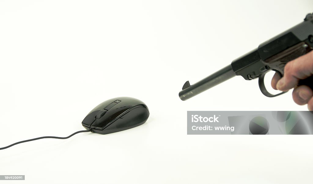 Mouse Hunting A pistol pointed at a computer mouse on a white background with copy space.  Frustation? Aiming Stock Photo
