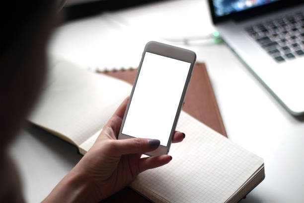 istock Mobile phone mockup with blank screen on white background for advertising, featuring a hand 1849201169