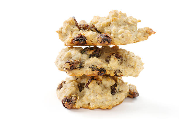 pila di tre farina d'avena uvetta biscotti isolato su bianco - oat oatmeal isolated stack foto e immagini stock