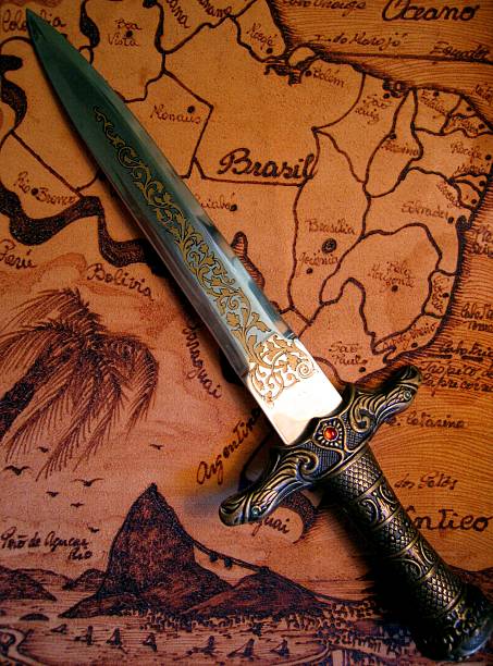 Dagger and Map Dagger on leather map of Brazil. swashbuckler stock pictures, royalty-free photos & images