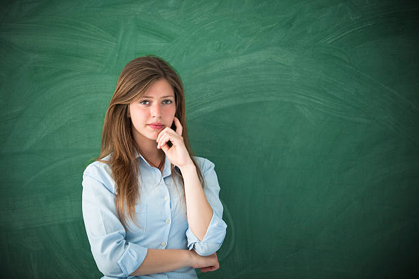 istock Woman with thinking expression in front of green board 184921018