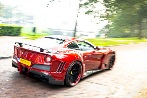 Ferrari F12 Novitec N Largo S sports car in the streets of Zwolle. The Novitec N Largo S is based on the Ferrari F12 Berlinetta and equiped with a high performand V12 engine and a widebody with components made from the hitech material carbon. NOVITEC builds the N-LARGO S high-performance sports car in a select limited edition.