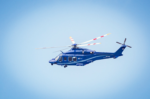 Helicopter Agusta-Westland AW139 PH-PXY of the Dutch Police Aviation Service fitted with camera's for surveillance. The Helicopter is flying in mid air and searching for shoplifters in Kampen, The Netherlands.