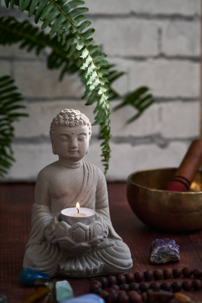 istock stone statue of buddha with a candle 1849213386