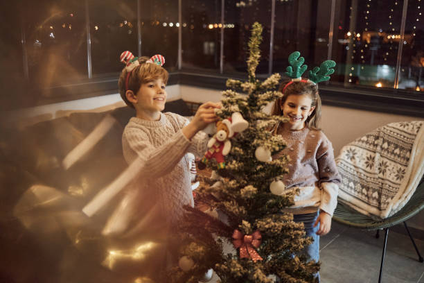 istock Happy children decorating Christmas Tree 1849214473
