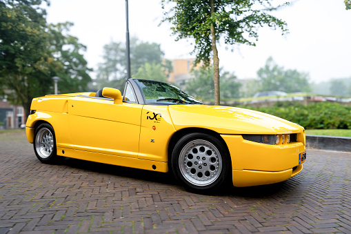 Alfa Romeo RZ Roadster Zagato convertible sports car driving on a street in the city of Zwolle during a sunny summer morning. The Alfa Romeo RZ (Roadster Zagato) is a sports car produced by the Italian automaker Alfa Romeo in collaboration with the renowned design house Zagato. Th RZ is a limited-production convertible version of the Alfa Romeo SZ (Sprint Zagato)