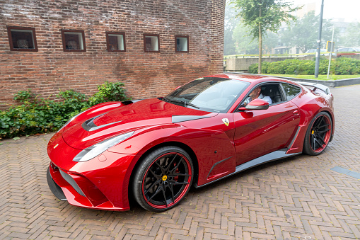 Ferrari F12 Novitec N Largo S sports car in the streets of Zwolle. The Novitec N Largo S is based on the Ferrari F12 Berlinetta and equiped with a high performand V12 engine and a widebody with components made from the hitech material carbon. NOVITEC builds the N-LARGO S high-performance sports car in a select limited edition.