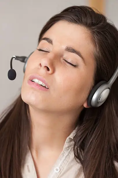 "Receptionist woman sleeping at work. It can be useful to concepts like sleeping problems, bad support or tiredness."
