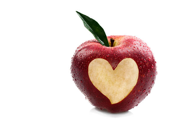 istock Water on Red Apple With Heart Shape 184922456
