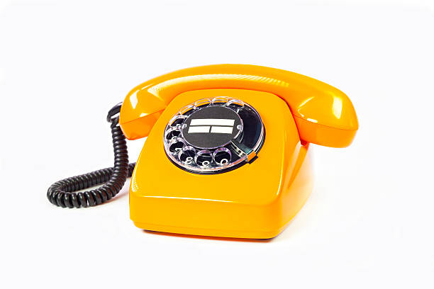 telefono retrò arancione - obsolete landline phone old 1970s style foto e immagini stock