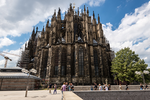 Cologne, Germany - June 11, 2022: People in the front of the gothic Cologne cathedral. It is a cathedral belonging to the Catholic Church situated in the city of Cologne, North Rhine-Westphalia.