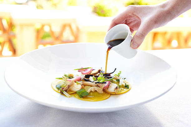 istock Waiter pouring au jus sauce over pasta dish 184923097