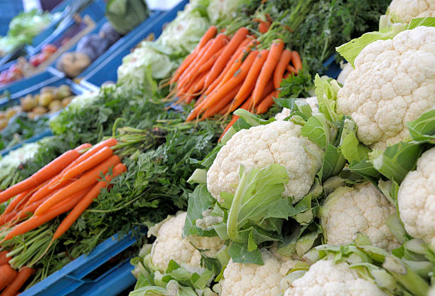 Abstract background of many piles of colorful fresh vegetables.