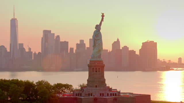 AERIAL Around the Statue of Liberty on Liberty Island, NYC at sunrise