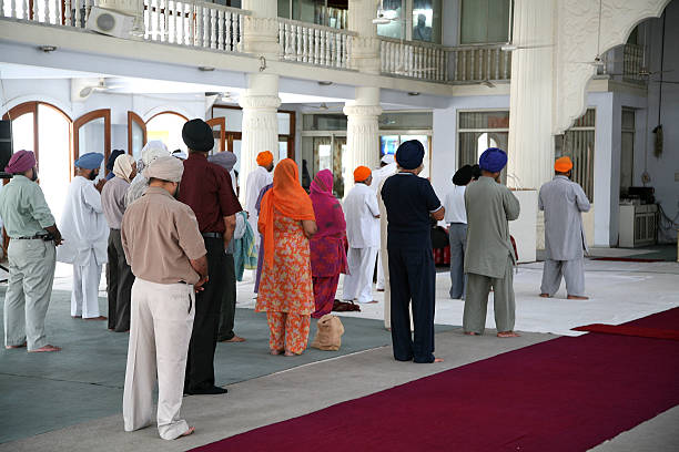 People praying in a Sikh temple stock photo