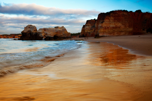 Famous beach Praia da Rocha at dusk in Portugal with huge rocks.