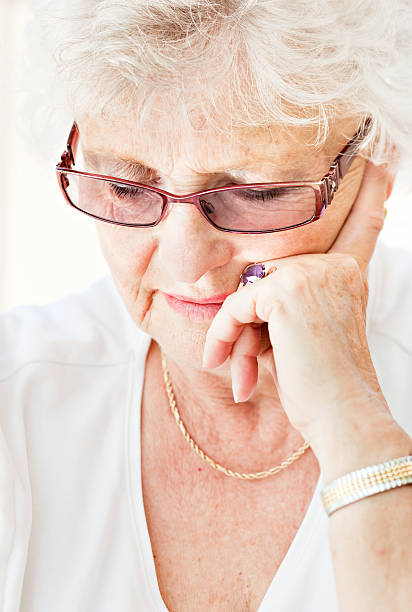 istock Concentrated senior female reading 184924560