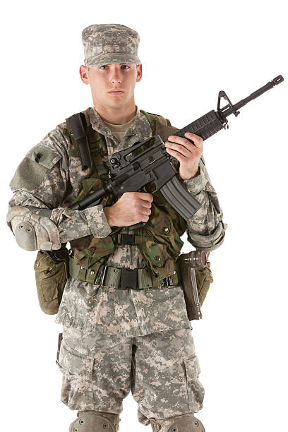 istock Army soldier holding a machine gun 184924831