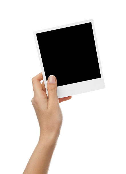 istock Hand holding blank photo paper 184925043