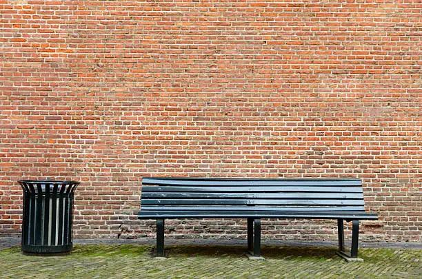 Photo of Empty bench and garbage bin