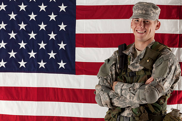 istock Army man standing in front of American flag 184925175