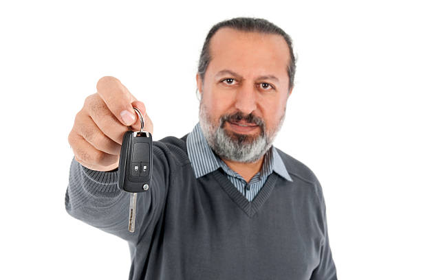 istock man gives car key 184925736